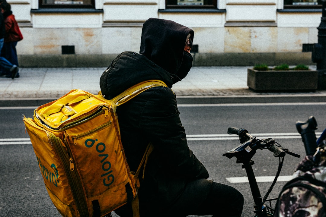 team-03 delivery-person-with-a-yellow-backpack-on-a-bicycle-3eguf0lvppm